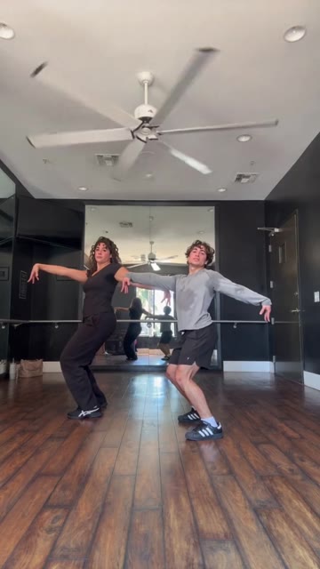 Thriller Dance AI: Two-Person Dance, 1.5 seconds: Two distinct dancers on the wooden floor
